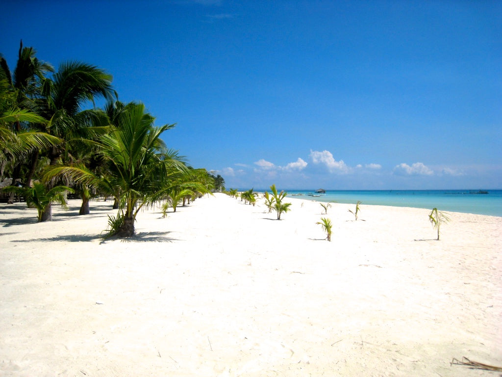 Soft golden light over calm waters on Batayan Island’s empty coast